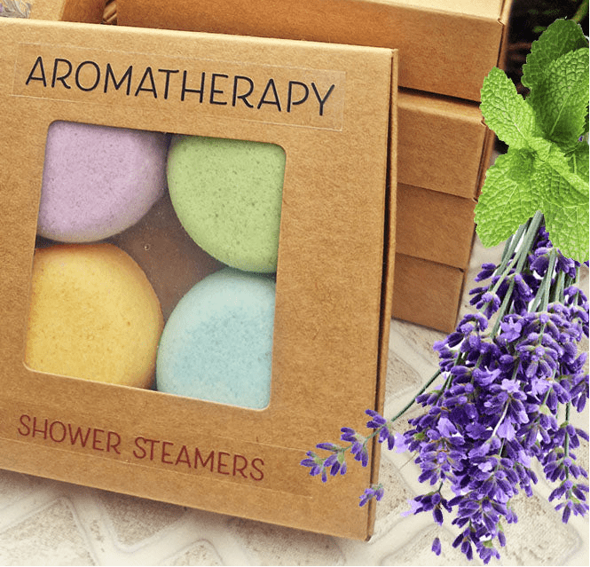 Box of aromatherapy shower steamers with lavender flowers on a stone surface
