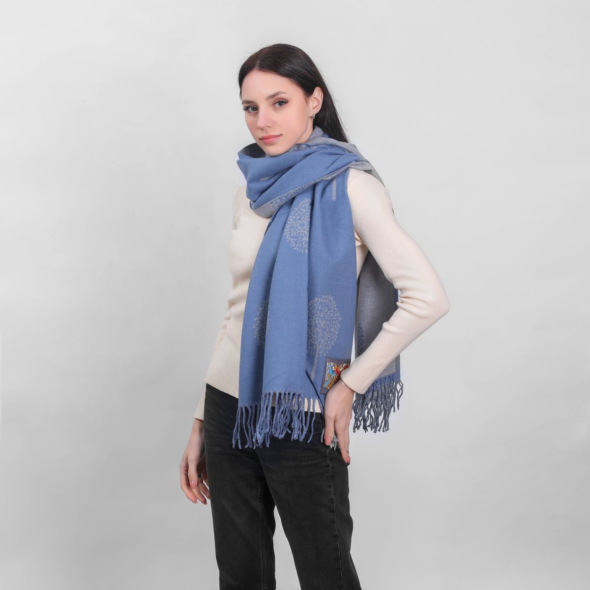 Woman wearing a blue scarf with a white background