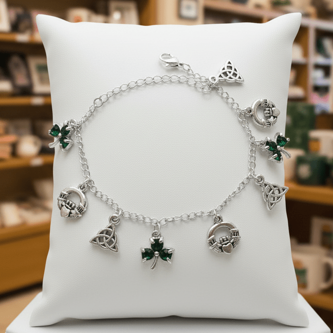 Silver bracelet with charms on a white pillow in a store setting with 'Irish Imports' sign.