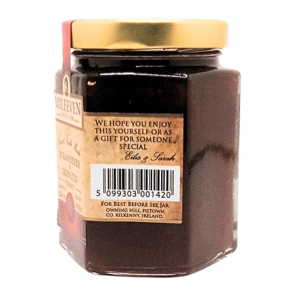 Jar of jam with a gold lid and label on a white background