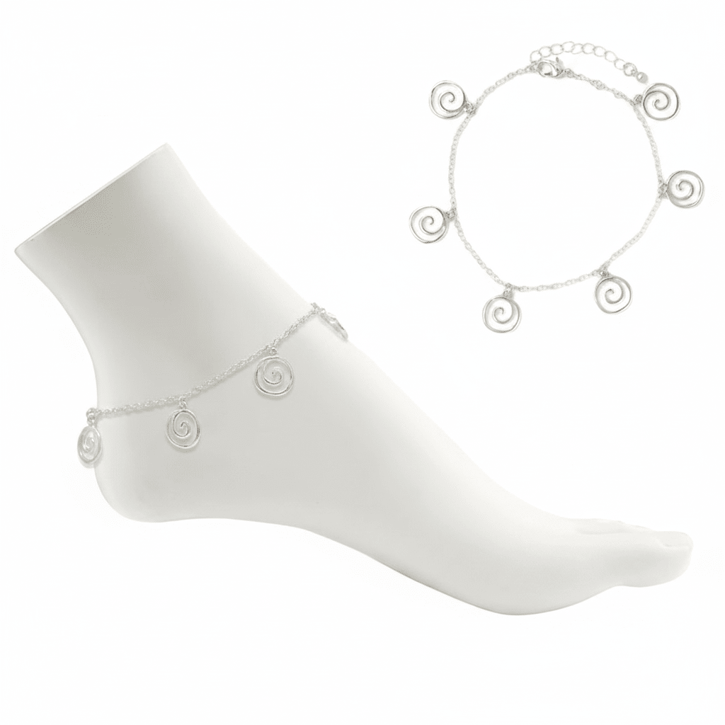 Silver anklets on a white mannequin foot and plain background